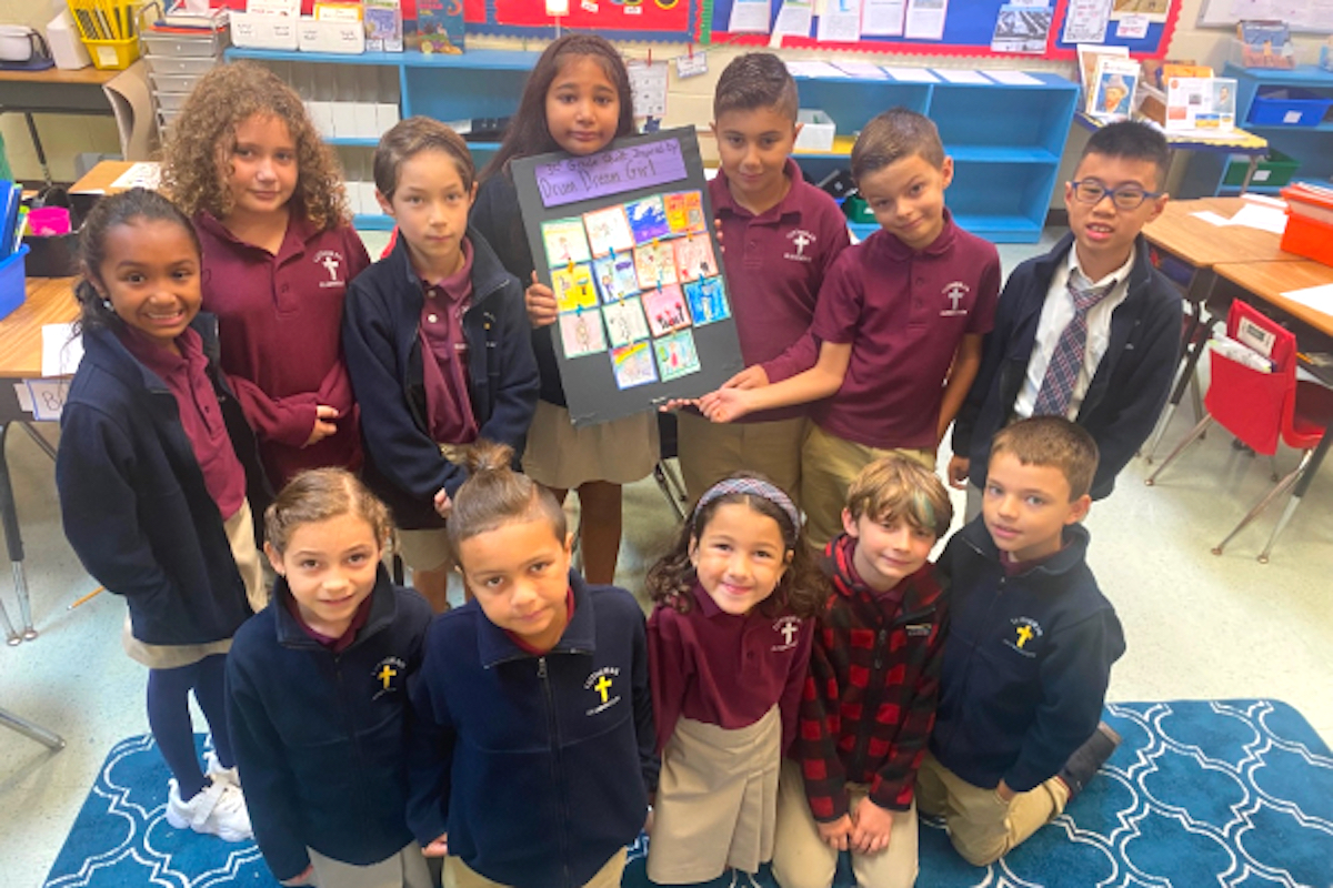 Students proudly showing their classwork